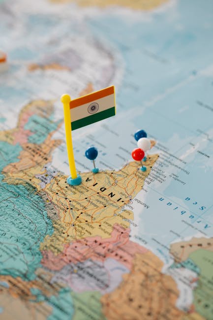 Indian map close-up with a flag and multiple colored pushpins.